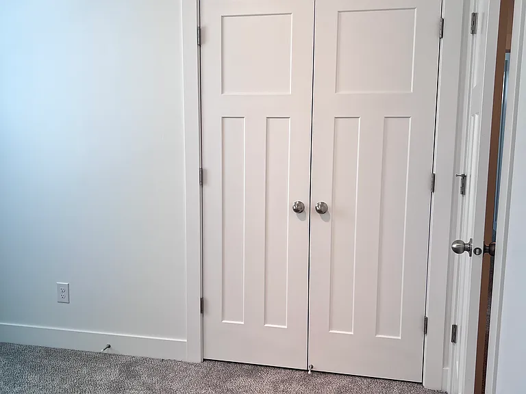 First bedroom closet with french doors