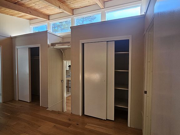 Bedroom. A few steps down (between closets) to kitchen/living area.