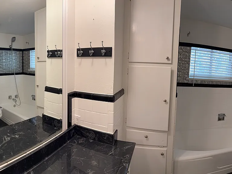 Hallway bathroom with bathtub and shower