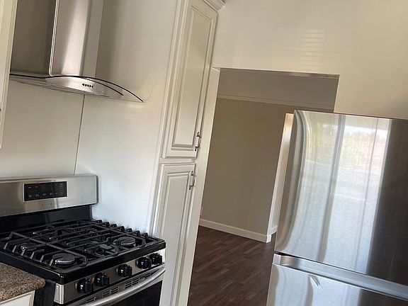 Kitchen includes Gas Stove and Refrigerator with separate Dining room