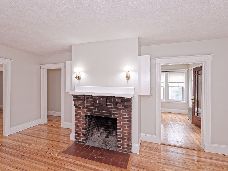 Living room with storage shelves on both sides of fireplace