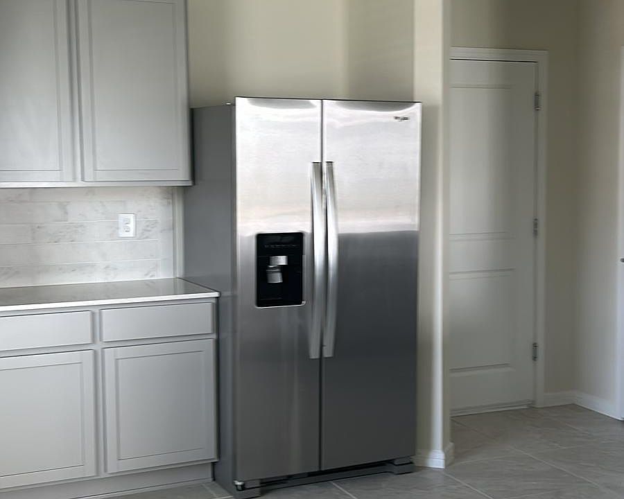 Brand new fridge and lots of cabinets for storage.