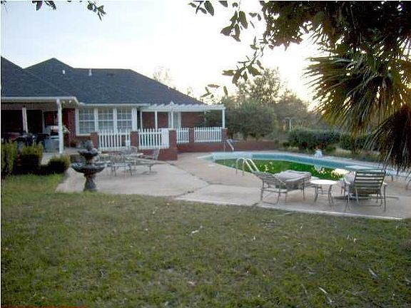 Nicely landscaped acre lot has a variety of trees.