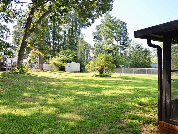 Fenced backyard with storage building