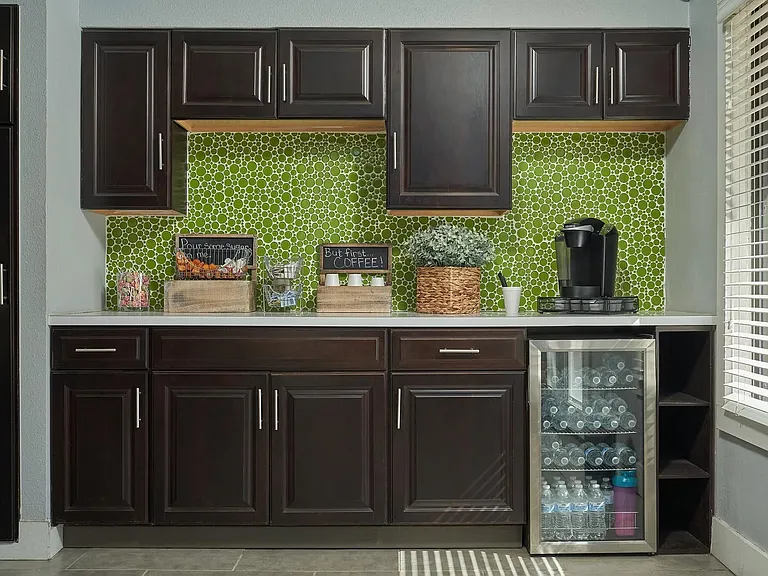 Experience modern living at Distinction Apartment Homes. This sleek kitchen features stylish cabinetry, vibrant backsplash, and convenient beverage fridgeperfect for everyday needs. Elevate your lifestyle today! Schedule a tour now!
