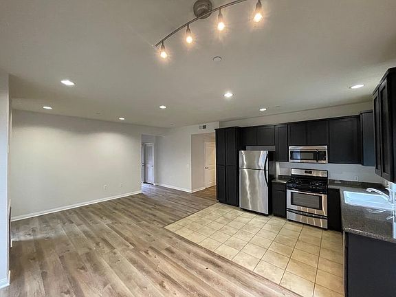Kitchen, dining area with view to the living room and entry hall