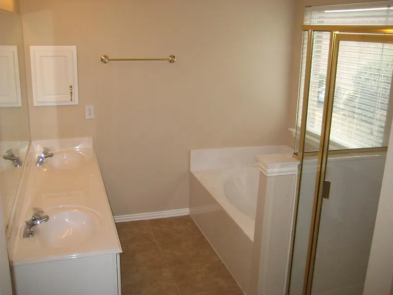Master bath with separate garden tub, shower, dual sinks