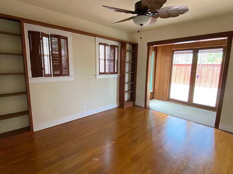 Bedroom w brown trim has a sunroom and patio