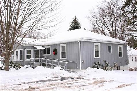 Large paved parking area for 2 cars on side of house