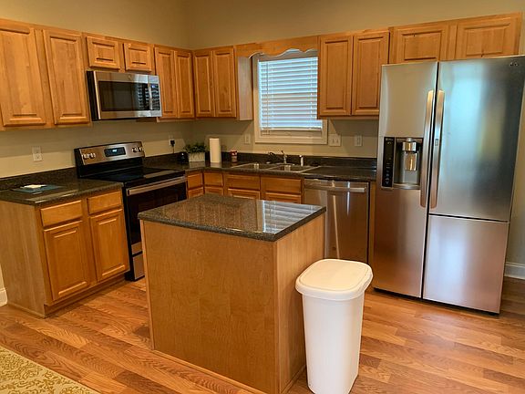 Kitchen includes refrigerator, stove oven, microwave and dishwasher.