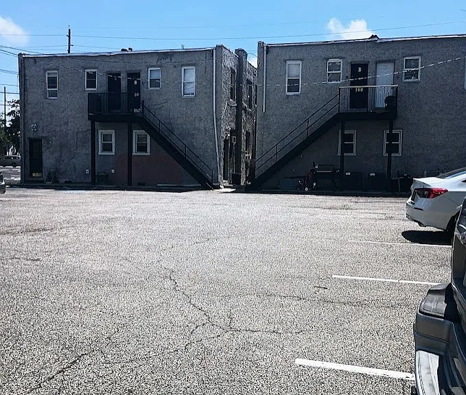 Back of the building- parking lot, Apartment is on the right side black door in this picture