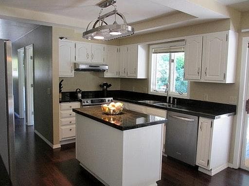 kitchen with Island, granite, and double ovens