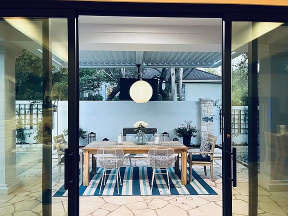 al fresco dining at dusk with pergola closed