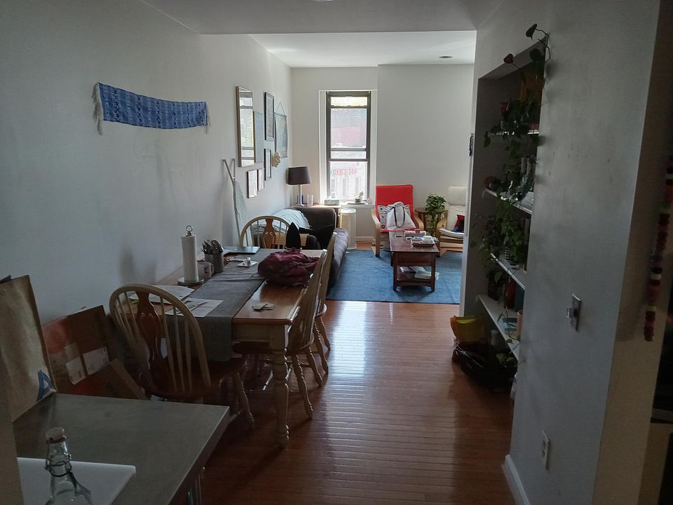 Dining area has a large built-in bookcase to the right.