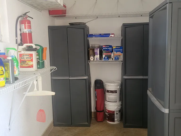3 empty storage cabinets in laundry room.