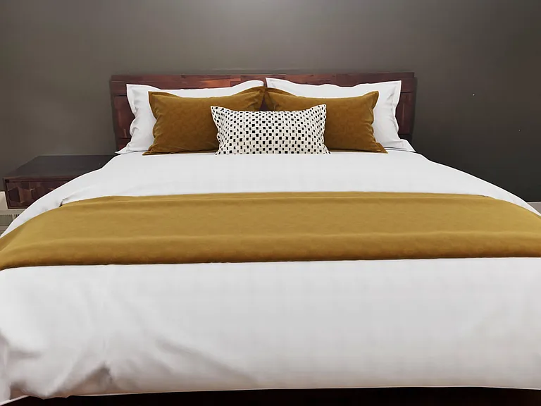 Well-appointed bedroom with a comfortable bed, nightstands, and hardwood floors for easy upkeep.