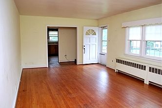 Living room looking toward front door & kitchen