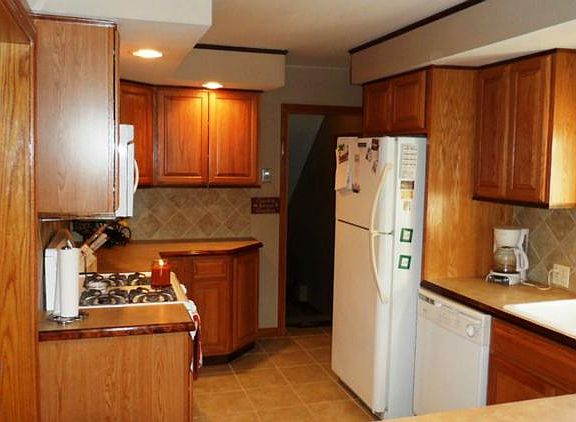 Kitchen has updated cabinets and flooring