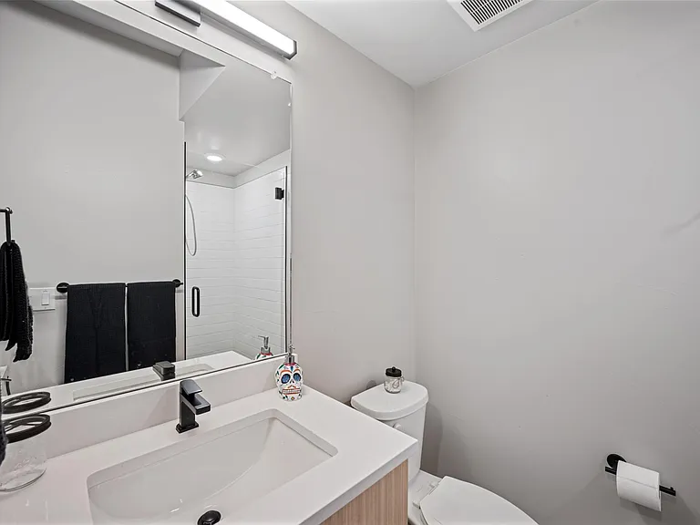 Yippie Ki yay!This en suite bathroom is tucked away behind the wellness room/Murphy bedroom and has it's own shower, sink, and toilet. It has everything you need to freshen up after a sweat session or whatever your day throws at you. Go get em tiger!