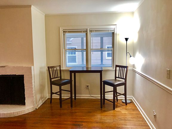 Hardwood floors in the dining area and living area with a fireplace