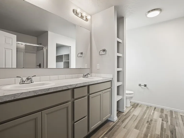 Primary suite Bathroom, featured double vanity, built in storage and shower.