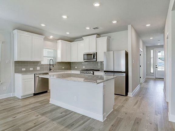 Fully equipped kitchen with a large island and granite countertops.