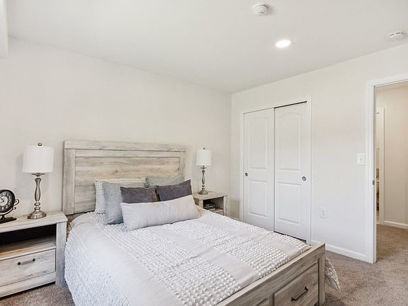 a spacious bedroom with a bed and a closet