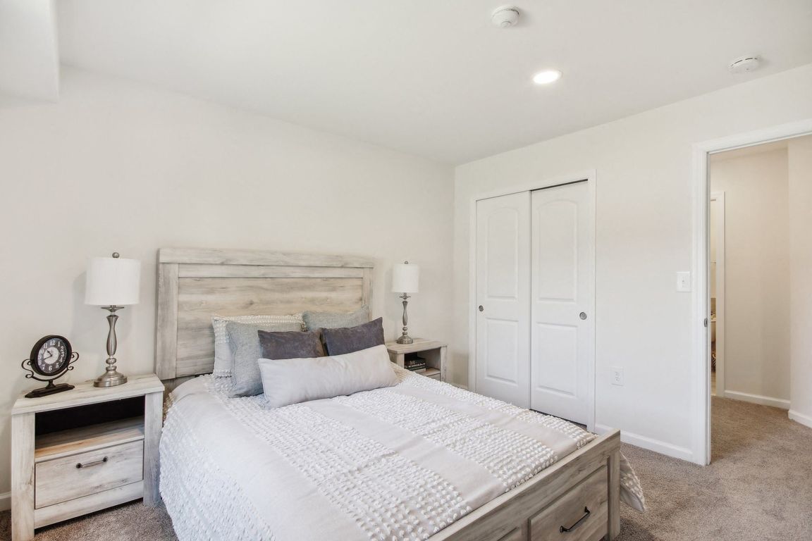 a spacious bedroom with a bed and a closet