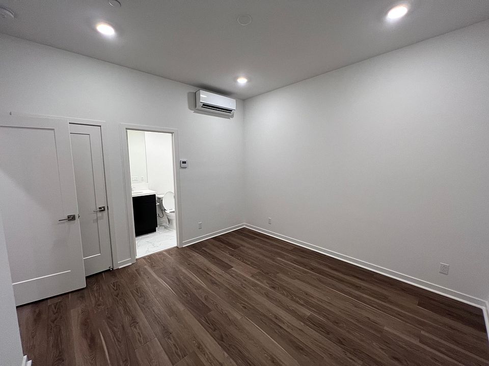 Facing en suite bathroom, in-room split off HVAC unit with separate thermostat.