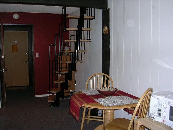 Brand new stairwell to loft. View is from living room to front entry door.