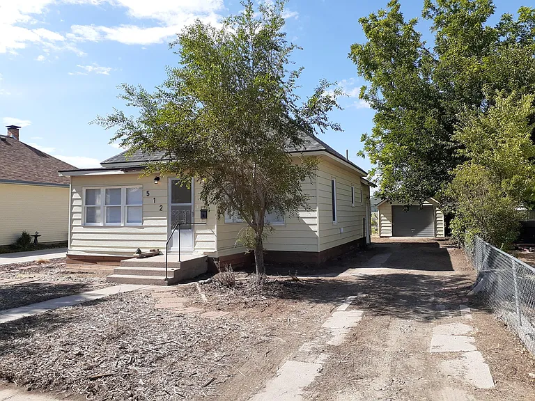 Large yard with a sizable driveway.