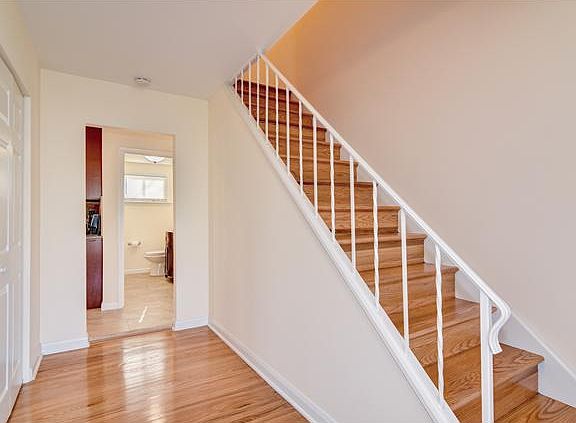 Refinished hardwoods in foyer hall and stairs