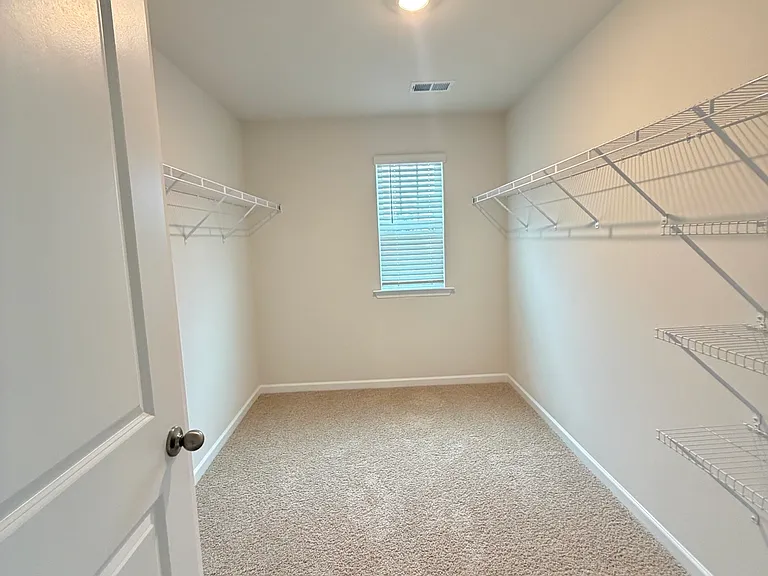 Walk-in closet in primary bedroom.