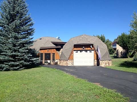 street view of house and one car garage summer