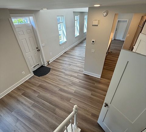 Great room, kitchen, bar seating and dining room on first floor with cathedral ceilings allows for natural lighting.