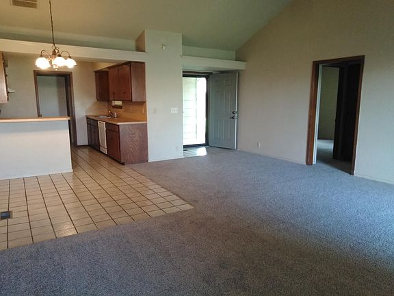 photo in living room of dining bar area and kitchen entry