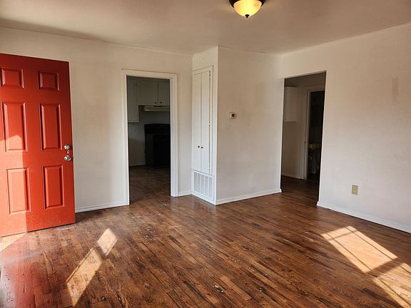 Living room with doors to kitchen ans hallway