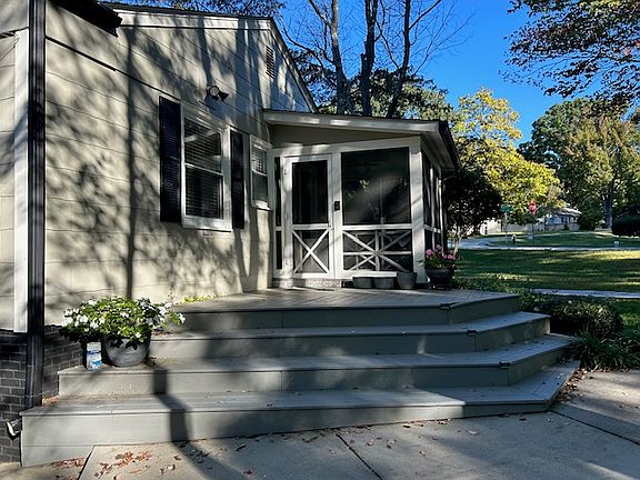 Paved driveway and wooden deck