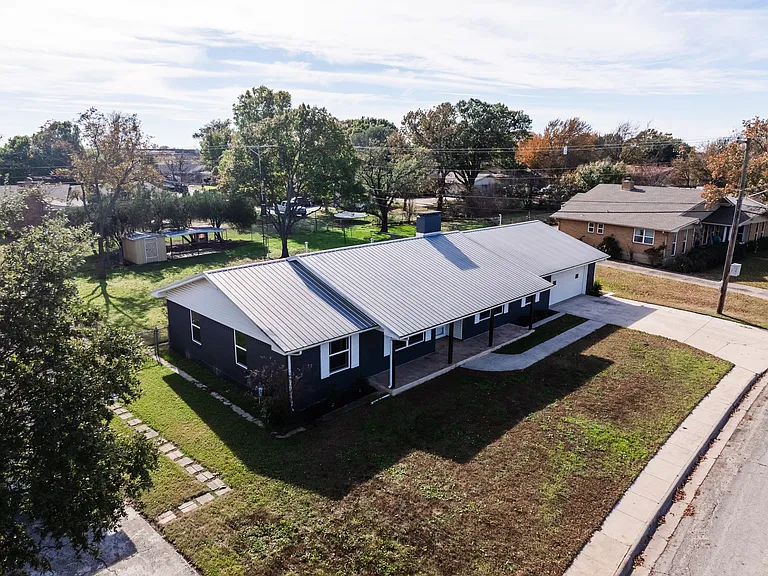 Aerial drone view of the full property showing driveway and neighborhood