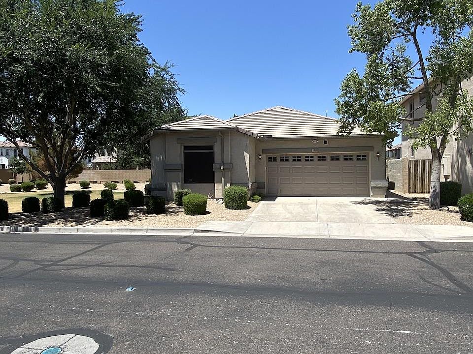 Front of house with 2 car garage, coated floor. Remotes and key code for door.