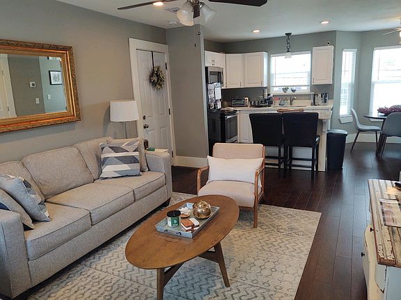 View of living room and kitchen with lots of natural light.