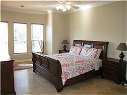 Dramatic master is privately located downstairs & features Lake view, double crown millwork, 2" blin