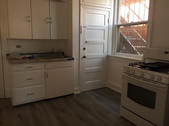 Kitchen with new gas range & fridge, granite countertop