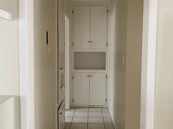 Hallway that leads to bathroom on left, and master bedroom on right.