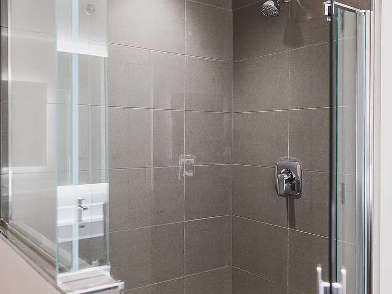 Serene bathrooms with spa-like glass showers with tile surround