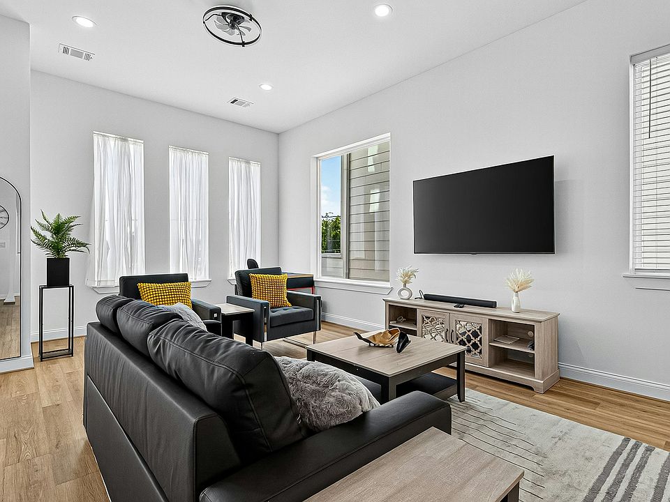 Living Room Relax in the stylish living room with smart TV, bright natural light, and cozy seating.