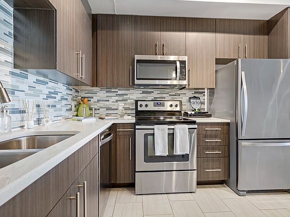 Kitchen and kitchen island within open concept apartment in Boca Raton.