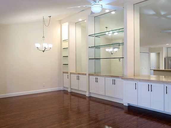 Large, open living area with large storage unit with marble tops