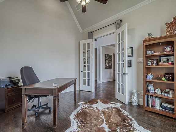 Home office with French doors, tall ceilings and hand scraped hardwood floors.