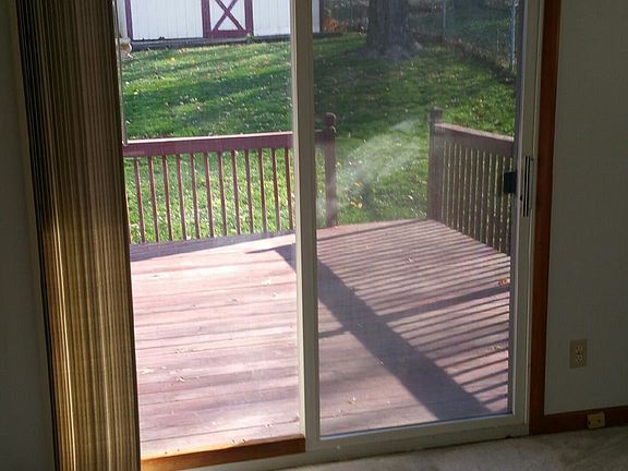 small room with sliding glass doors to back porch